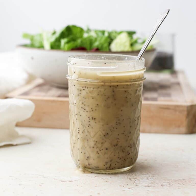A jar of homemade vegan poppy seed dressing.