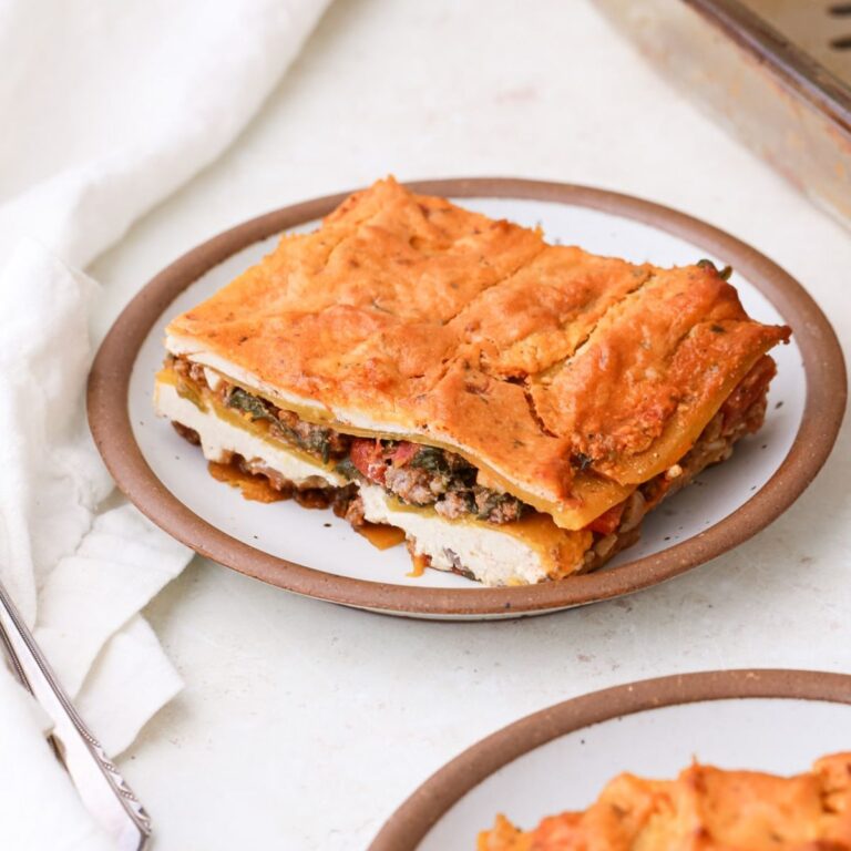 A couple pieces of homemade dairy free lasagna with butternut squash noodles on small plates.