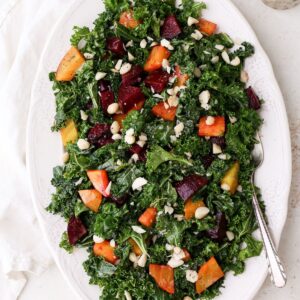 Roasted beet and kale salad with golden and red beets, roasted macadamia nuts, and poppy seed dressing.