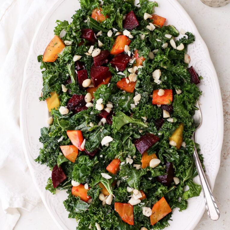 Roasted beet and kale salad with golden and red beets, roasted macadamia nuts, and poppy seed dressing.