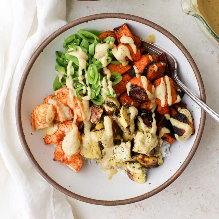 Dragon bowls with rice, roasted vegetables, fresh crunchy vegetables and a creamy tahini sauce.