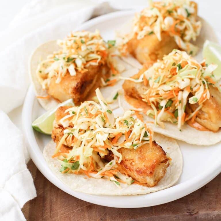A plate of crispy cod tacos with cilantro lime slaw.