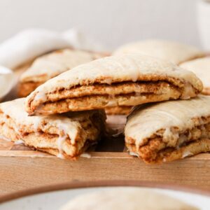 Triangular cinnamon roll scones with layers of cinnamon sugar.