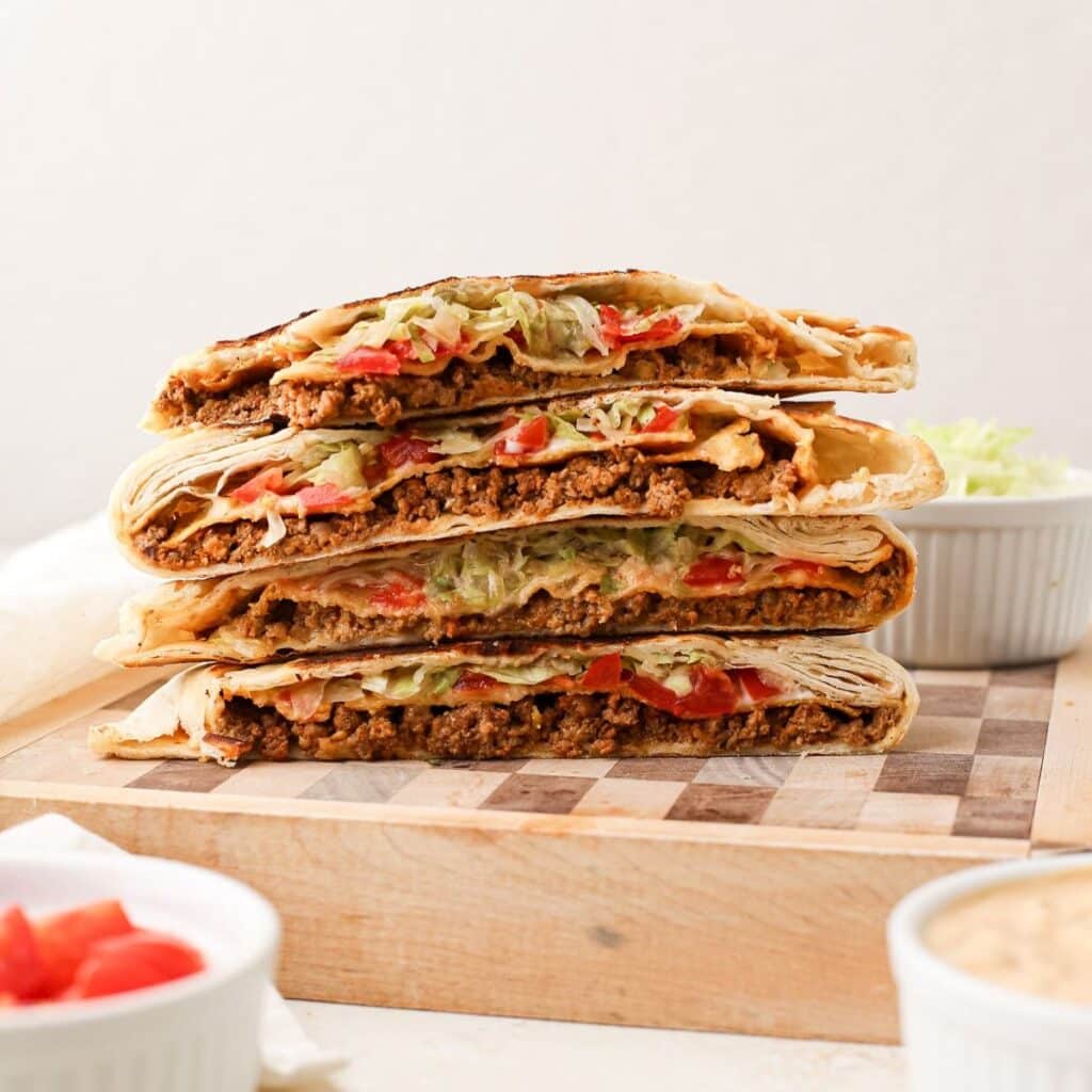 A stack of homemade crunchwrap supreme, but completely dairy free. A taco bell copycat recipe.