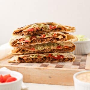 A stack of homemade crunchwrap supreme, but completely dairy free. A taco bell copycat recipe.