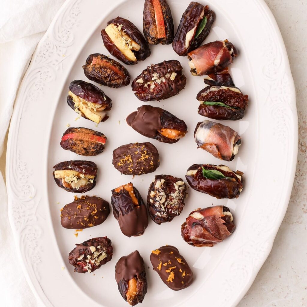 A plate of assorted stuffed dates, both sweet and savory.