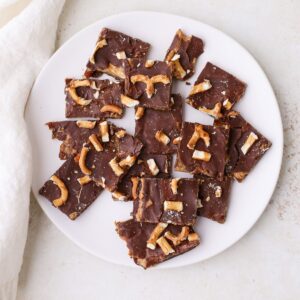 Date bark topped with crushed pretzels on a plate.