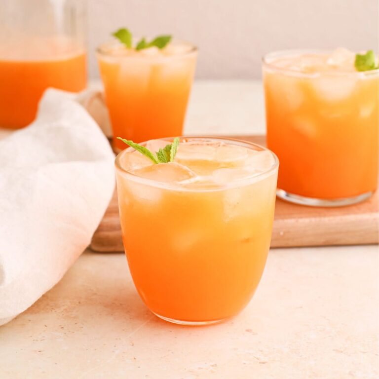 Glasses of homemade agua fresca with a sprig of fresh mint.